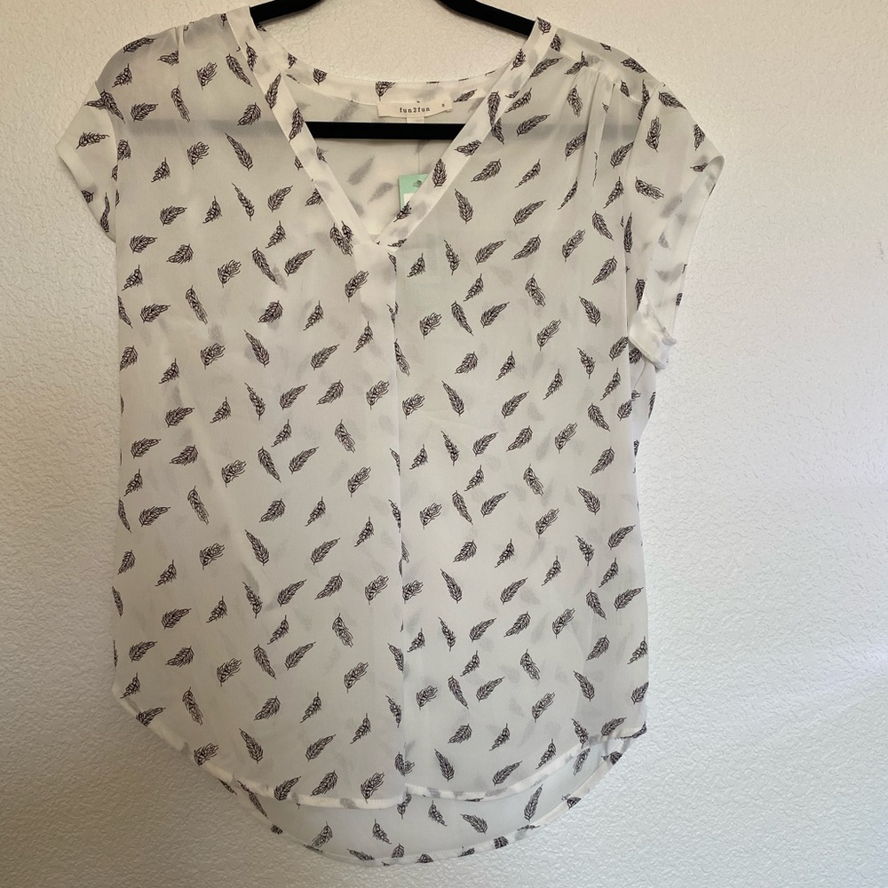 White top with black leaf pattern